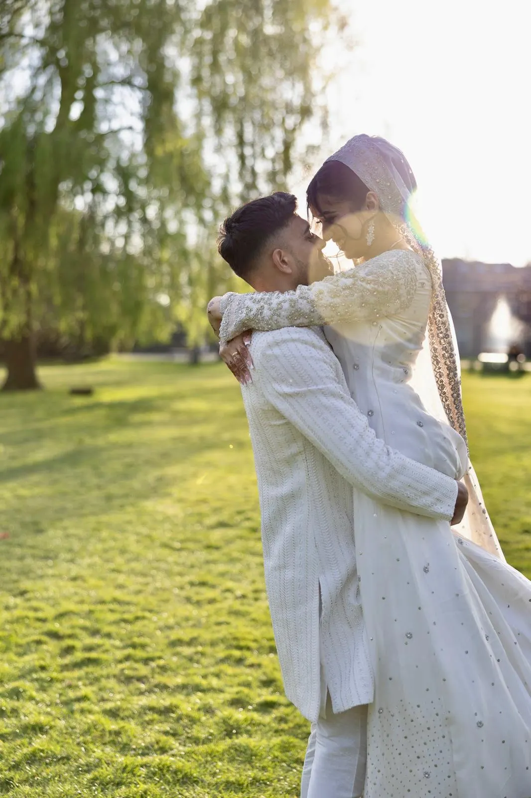 Couple embracing in late-afternoon light outdoors